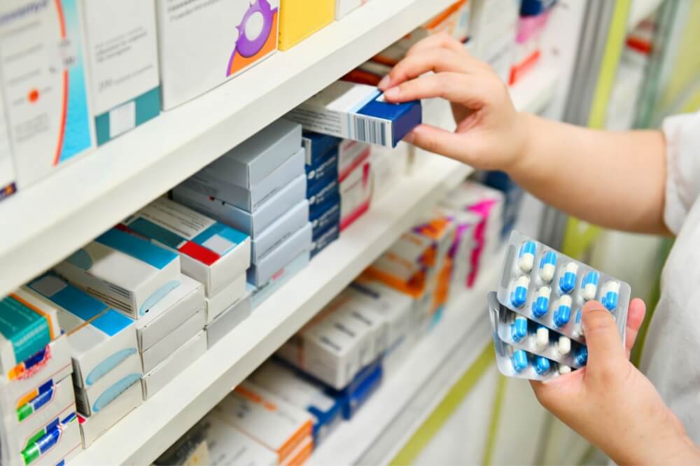 Pharmaceutical testing lab pharmacist grabbing drugs